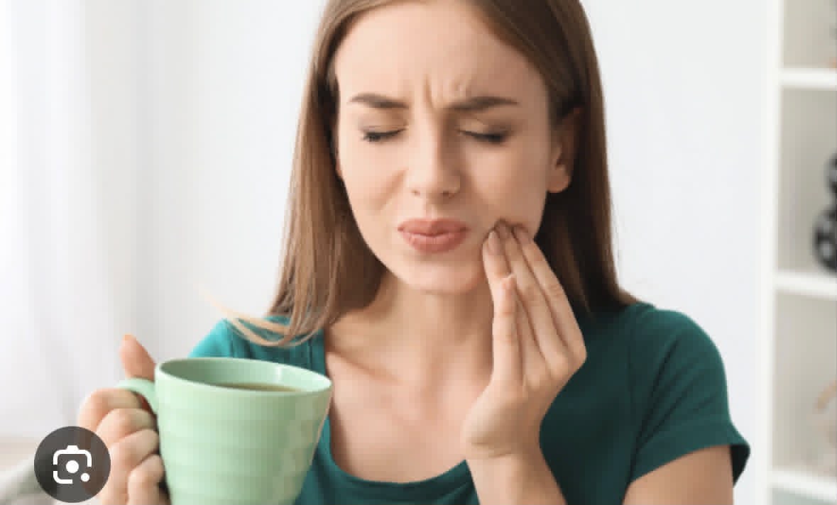 Woman with pain from sensitive teeth